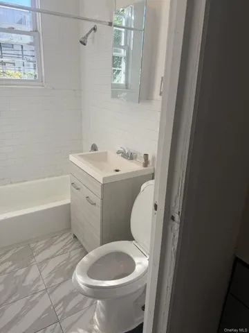 a bathroom with a sink toilet and bathtub