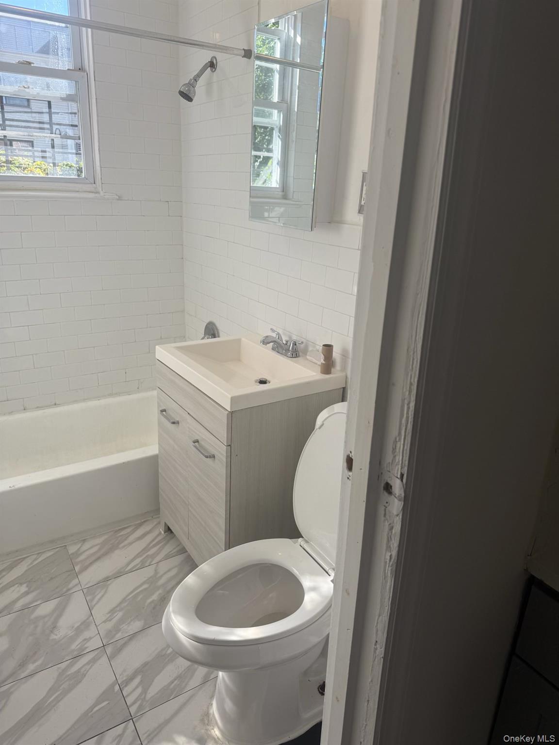 2280 Atlantic Avenue, Unit 1 Brooklyn, NY 11233 - Photo 5 of 5 a bathroom with a sink toilet and bathtub