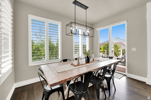 1132 South 1300th Street West Mapleton, UT 84664 - Photo 13 of 52 Spacious dining area featuring dark wood-finish flooring, a modern linear chandelier, and light gray wall tones
