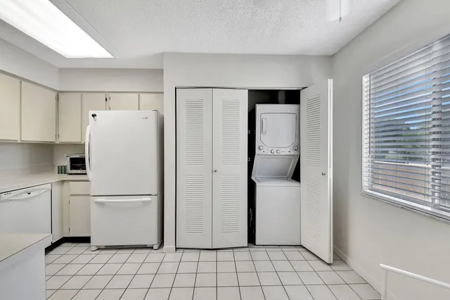 a white refrigerator freezer sitting in a kitchen