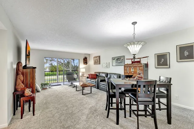a view of a dining room with furniture wooden floor and chandelier