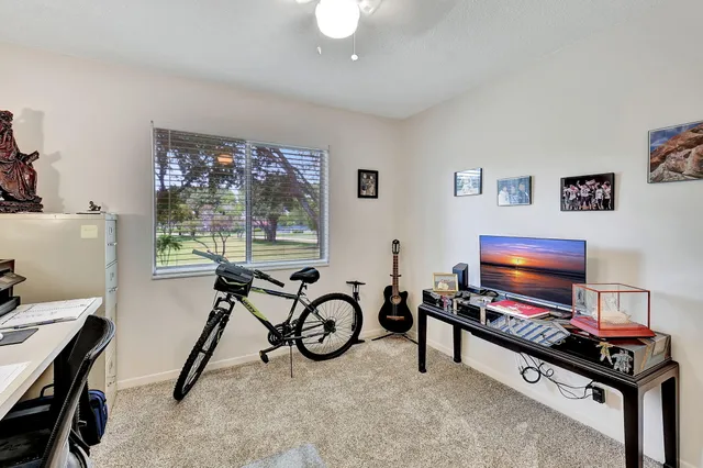 a view of a livingroom with furniture gym equipment and a flat screen tv