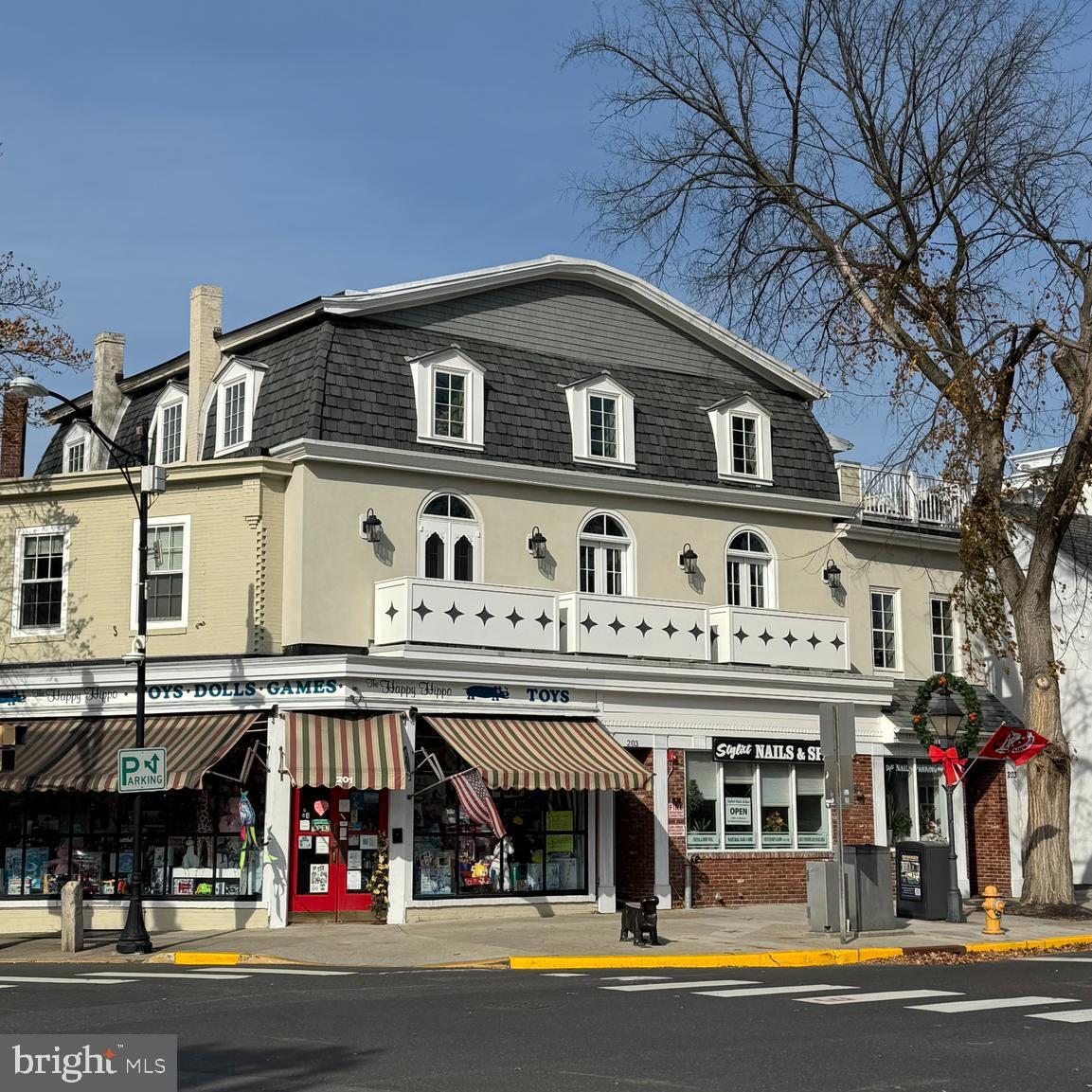 203 Kings Highway East, Unit A2 Haddonfield, NJ 08033 - Photo 1 of 9 a front view of a building with retail shops and large trees