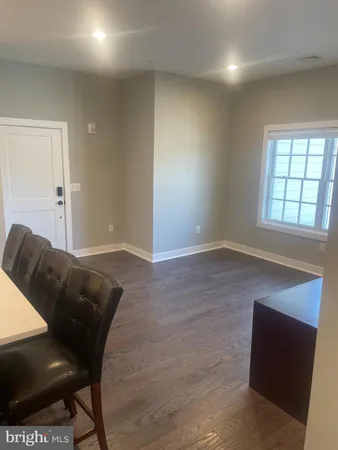 a living room with a couch and a potted plant