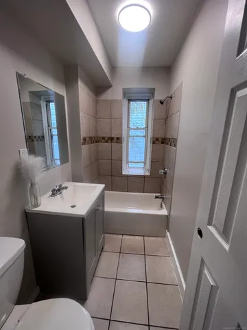 a bathroom with a sink a toilet and bathtub
