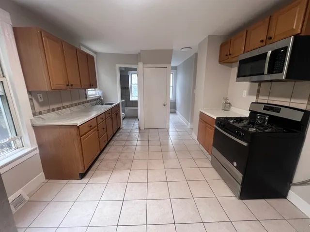 a kitchen with a stove top oven and cabinets