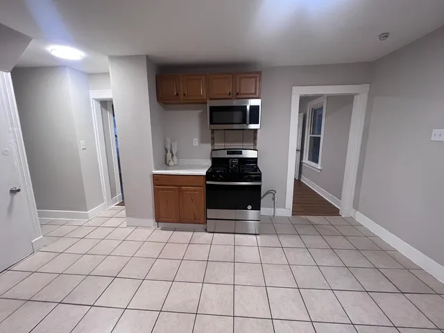 a kitchen with granite countertop a stove and a refrigerator