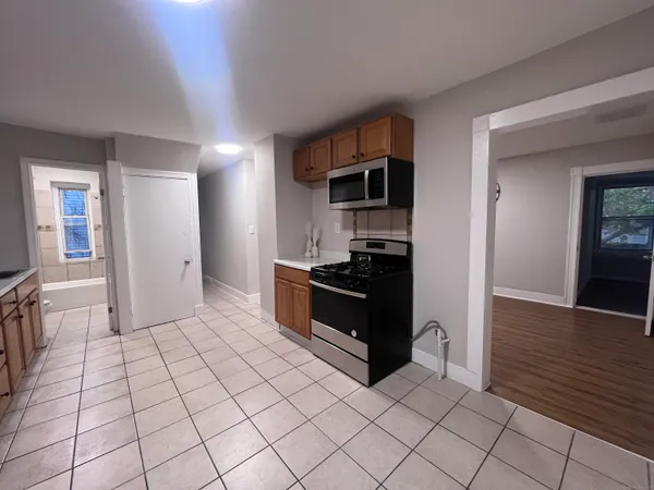 a kitchen with stainless steel appliances a refrigerator and a stove top oven