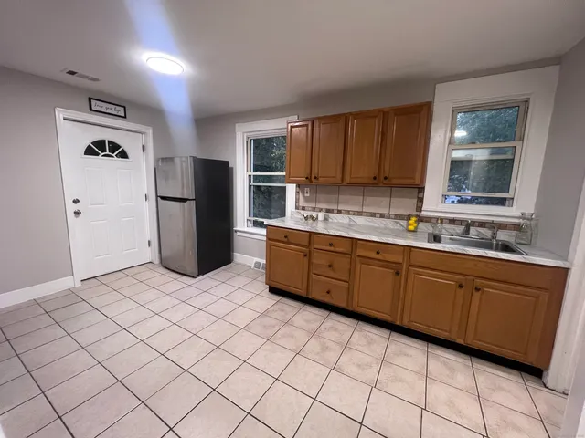 a kitchen with stainless steel appliances granite countertop a refrigerator sink and cabinets