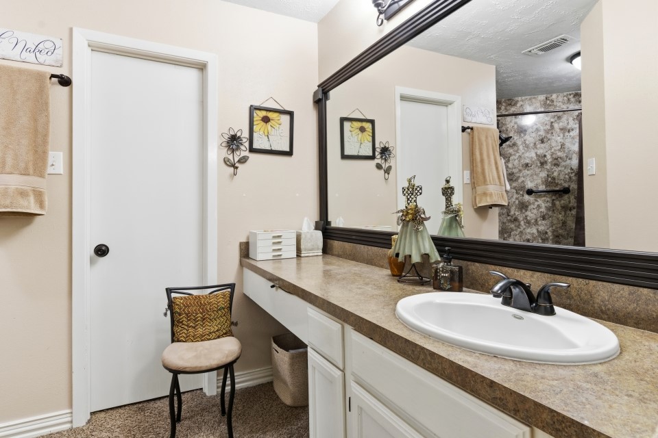 9211 Benwick Street Spring, TX 77379 - Photo 17 of 27 a bathroom with a sink and a mirror