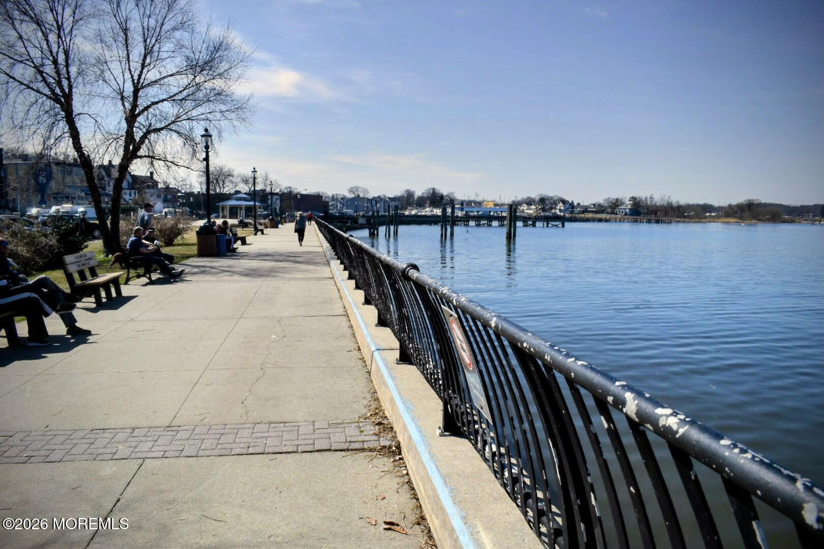 151 1st Street Keyport, NJ 07735 - Photo 22 of 24 a view of wooden deck and lake with trees in the background
