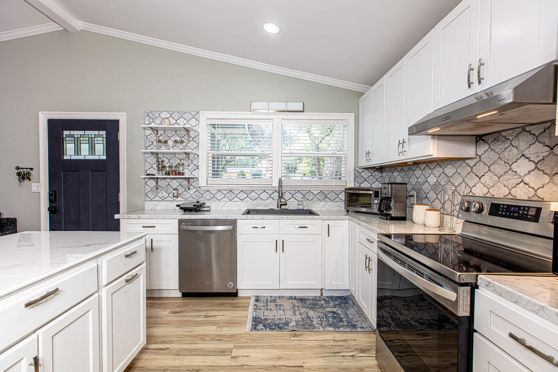 1013 Gloria Avenue Fort Walton Beach, FL 32547 - Photo 13 of 31 a kitchen with a sink stove and cabinets