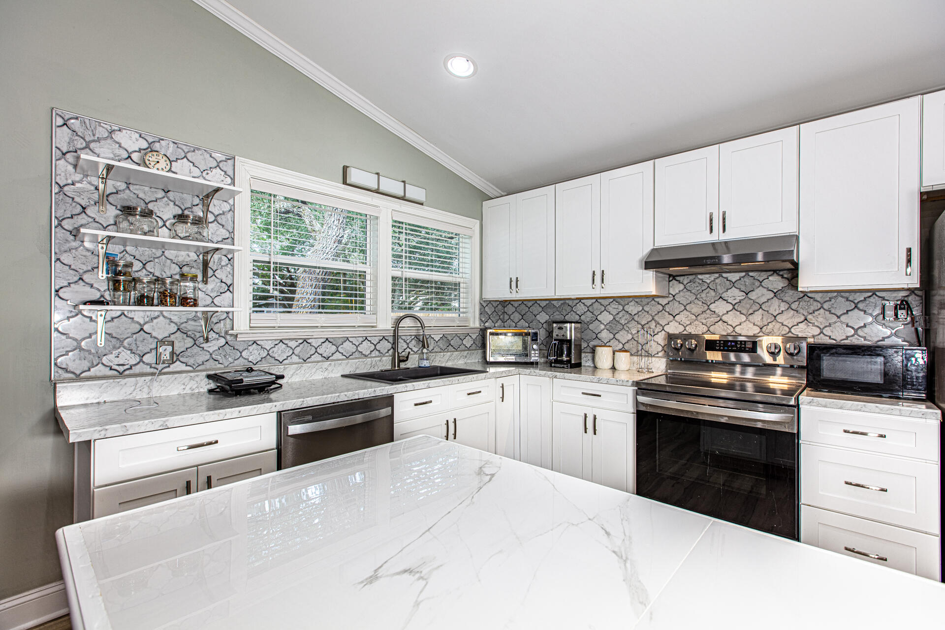 1013 Gloria Avenue Fort Walton Beach, FL 32547 - Photo 14 of 31 a kitchen with granite countertop cabinets stainless steel appliances and a sink