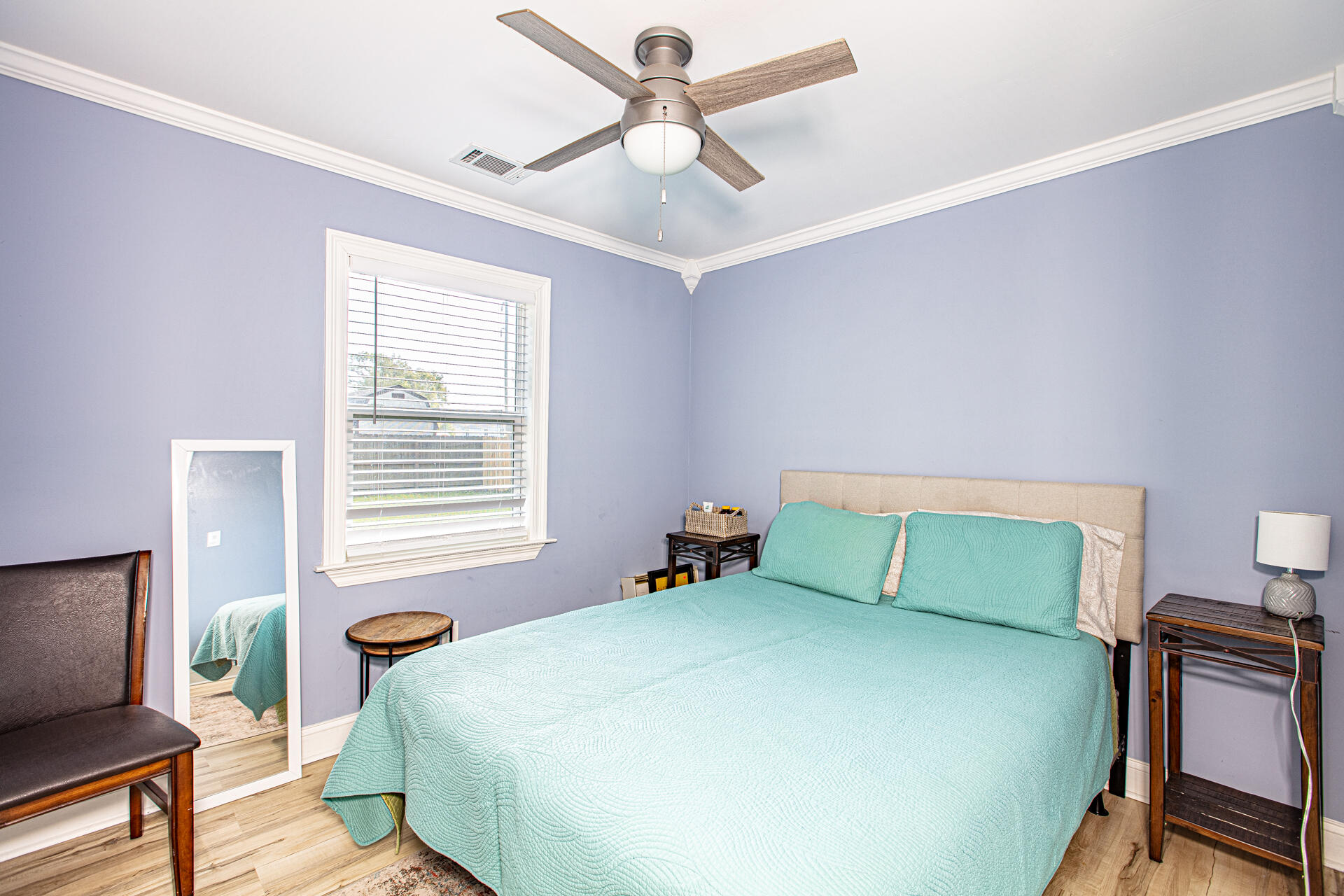 1013 Gloria Avenue Fort Walton Beach, FL 32547 - Photo 17 of 31 a bedroom with a bed and a chandelier