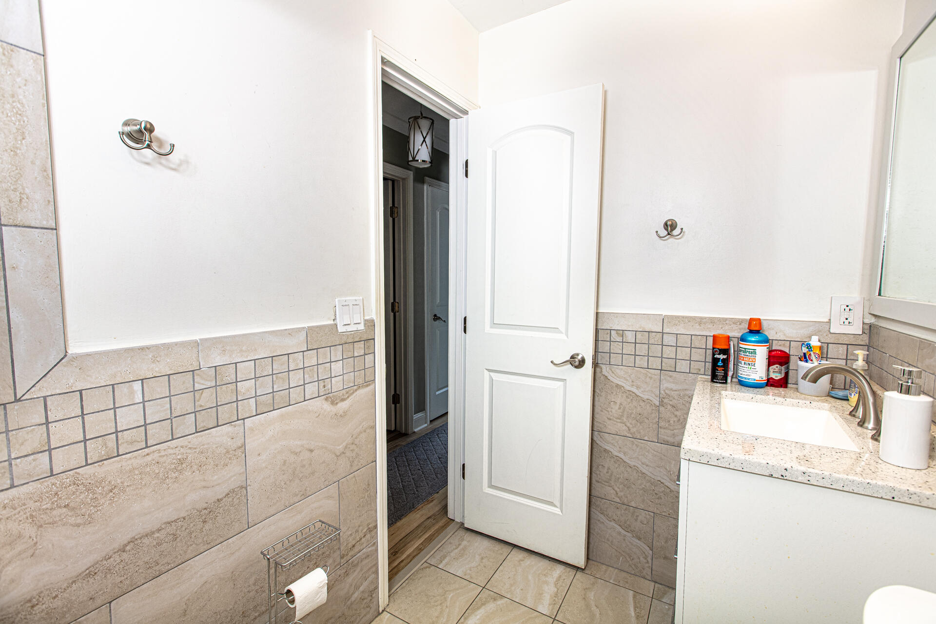 1013 Gloria Avenue Fort Walton Beach, FL 32547 - Photo 20 of 31 a bathroom with a granite countertop sink a mirror and shower