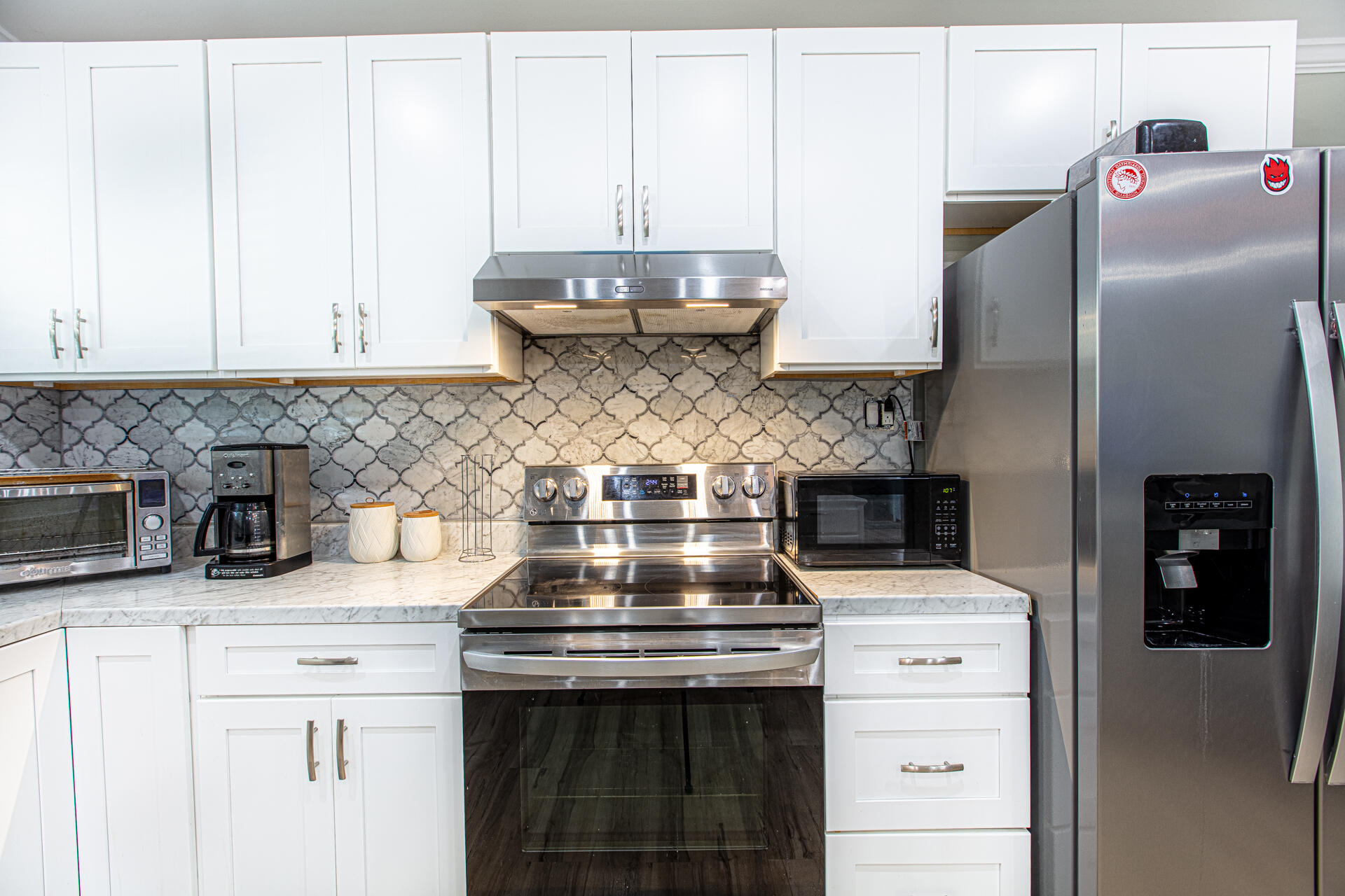 1013 Gloria Avenue Fort Walton Beach, FL 32547 - Photo 27 of 31 a kitchen with stainless steel appliances granite countertop a stove a refrigerator and a counter space