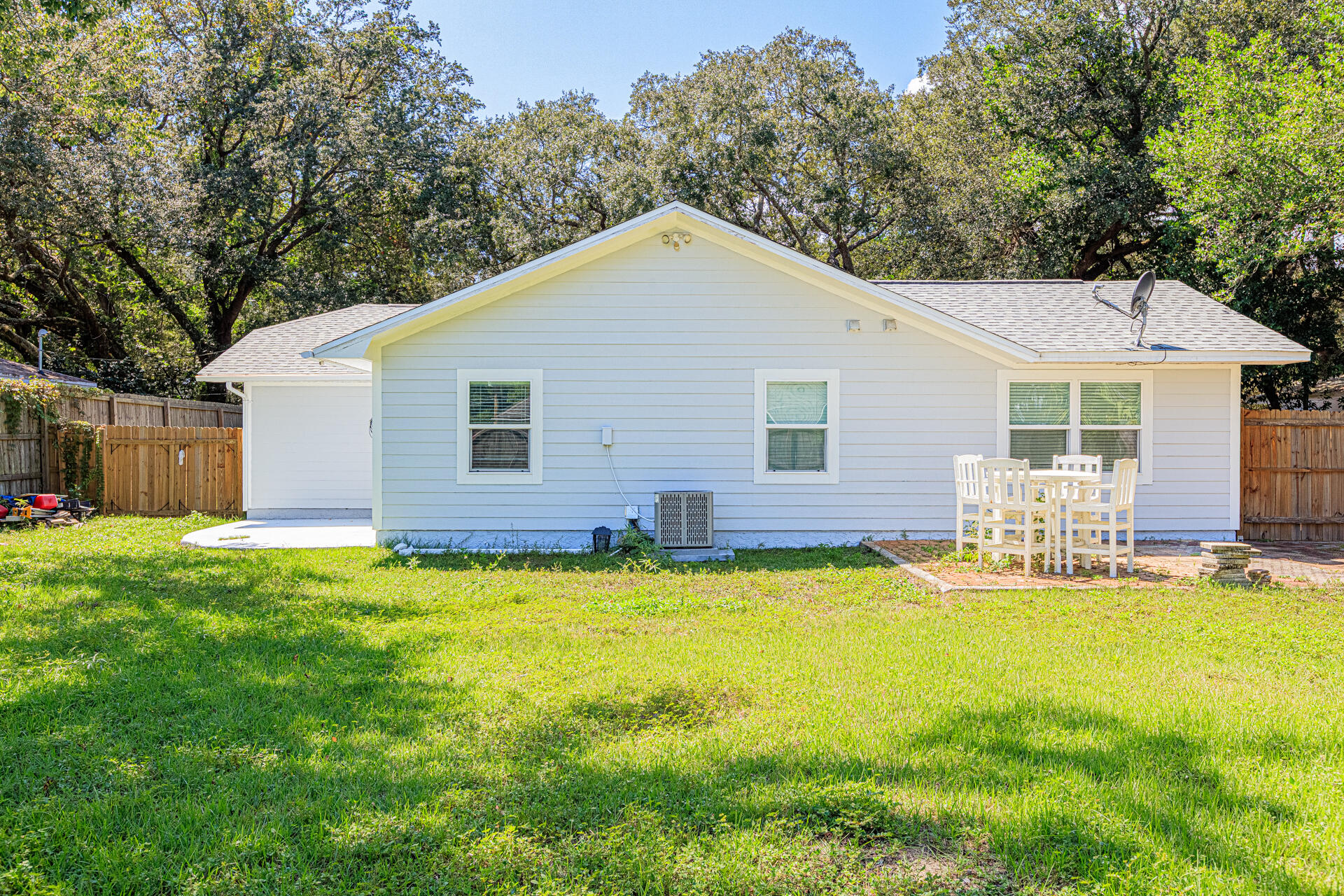 1013 Gloria Avenue Fort Walton Beach, FL 32547 - Photo 5 of 31 a view of a house with swimming pool and a garden