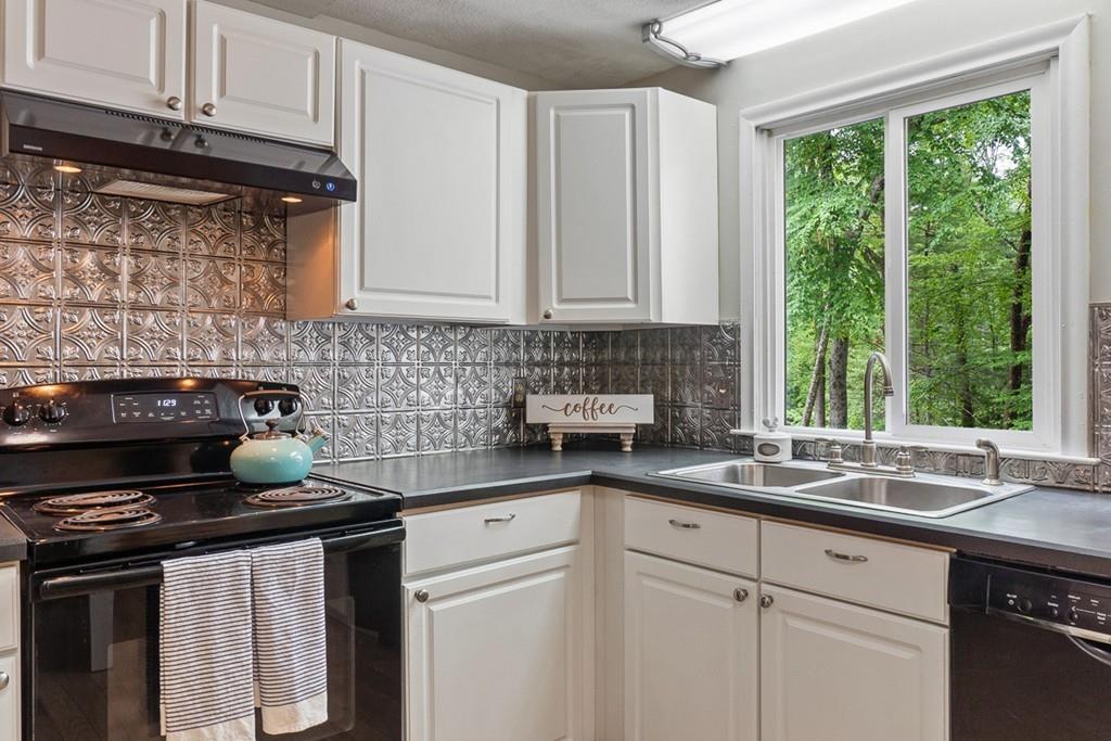 684 Burroughs Road Boxborough, MA 01719 - Photo 11 of 30 a kitchen with granite countertop a sink stove and cabinets