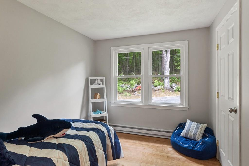 684 Burroughs Road Boxborough, MA 01719 - Photo 20 of 30 a bedroom with a bed and a window