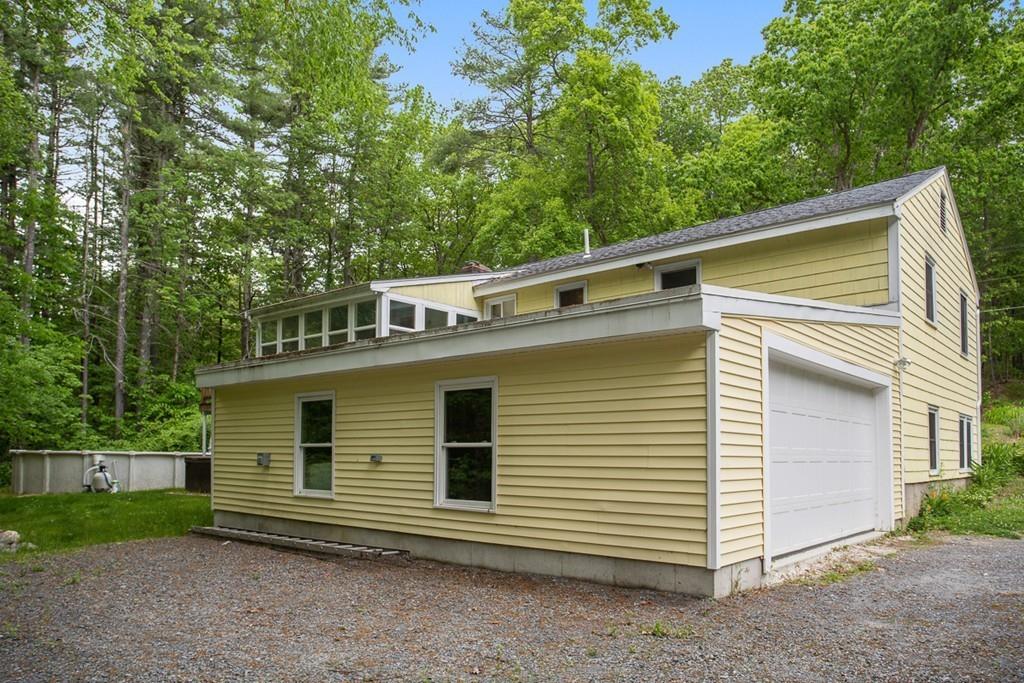 684 Burroughs Road Boxborough, MA 01719 - Photo 28 of 30 a side view of a house with a yard