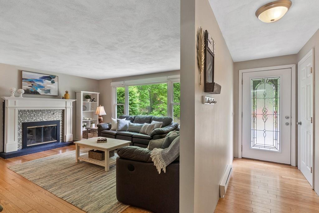 684 Burroughs Road Boxborough, MA 01719 - Photo 4 of 30 a living room with furniture and a fireplace
