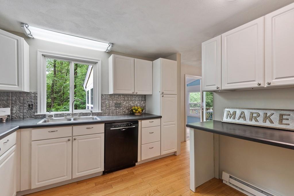 684 Burroughs Road Boxborough, MA 01719 - Photo 10 of 30 a kitchen with granite countertop white cabinets and white appliances