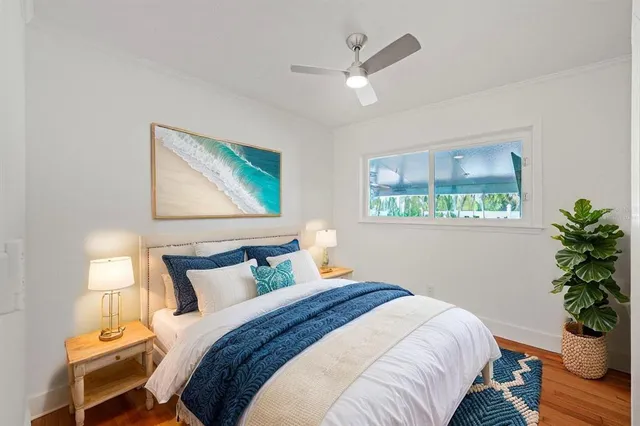 a bedroom with a large bed and a potted plant
