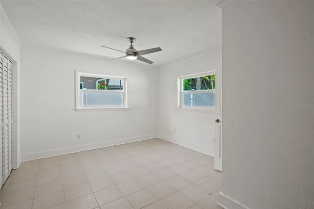 a view of empty room with ceiling fan