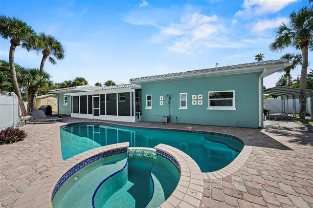 a view of backyard with outdoor seating and plants