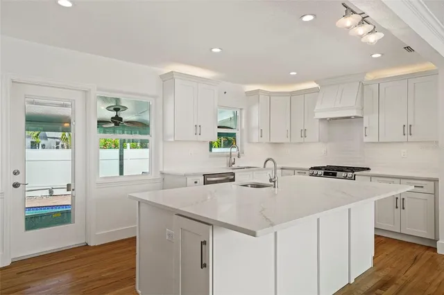 a kitchen with a sink stove and cabinets