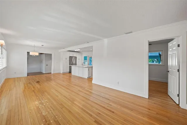 a view of empty room with wooden floor