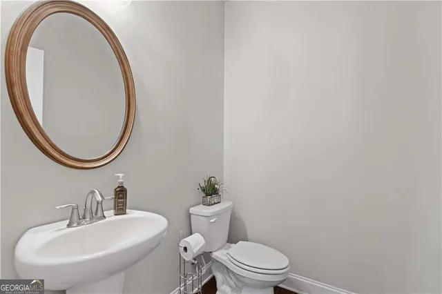 a bathroom with a sink a mirror and a toilet