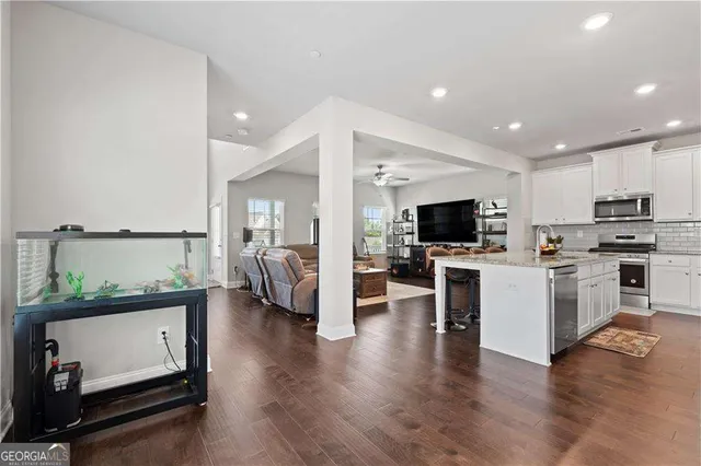 a view of kitchen with microwave a stove and cabinets