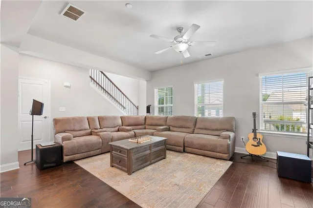 a living room with furniture and wooden floor