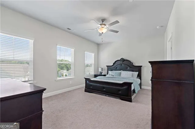 a spacious bathroom with a granite countertop sink a mirror and a shower