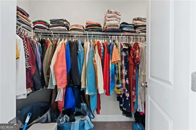 a bathroom with a granite countertop sink a toilet tub and shower