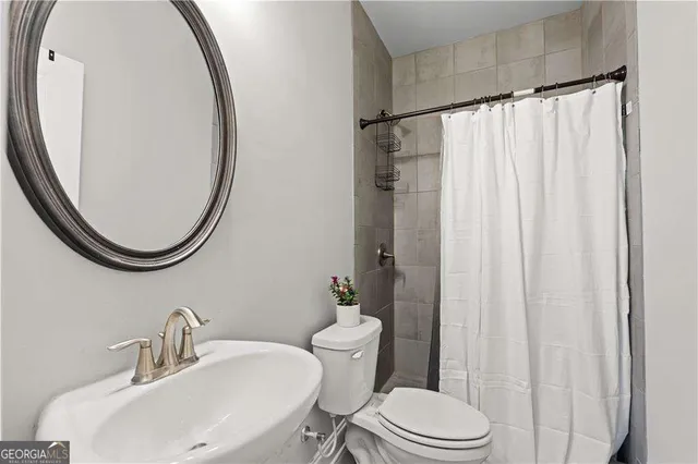 a view of a house with a yard and potted plants