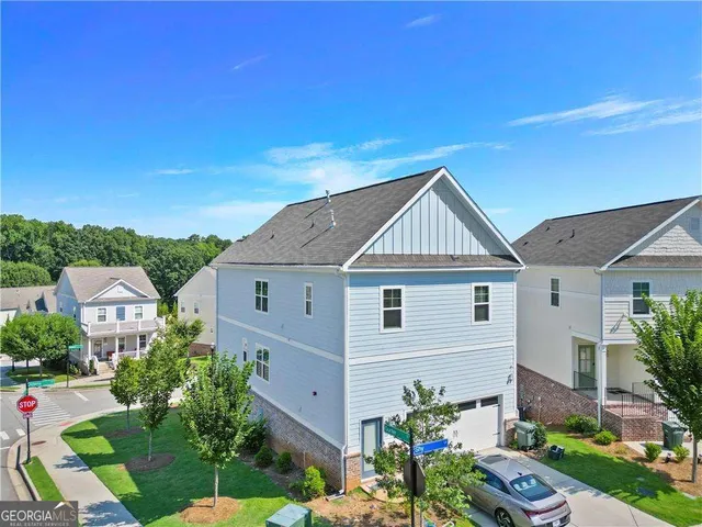 an aerial view of a house with a yard