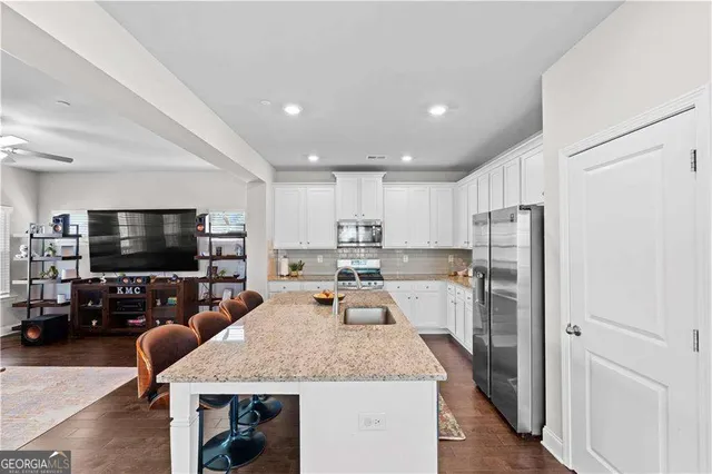 a large kitchen with a table and chairs in it