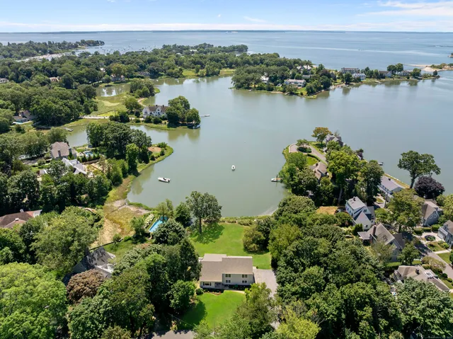 an aerial view of a houses with outdoor space and lake view