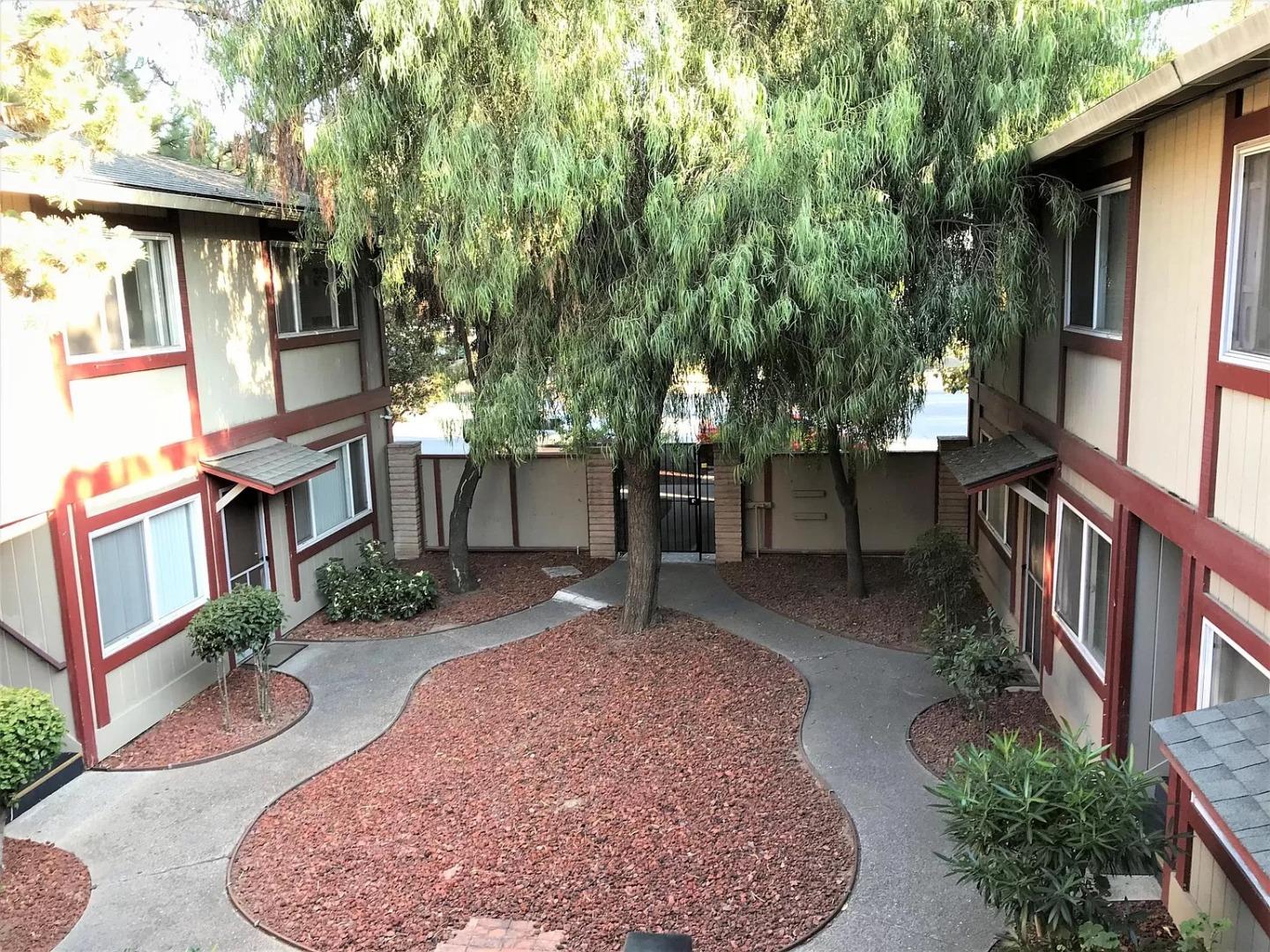 195 East Reed Street, Unit 4 San Jose, CA 95112 - Photo 1 of 11 a view of a patio with table and chairs and potted plants