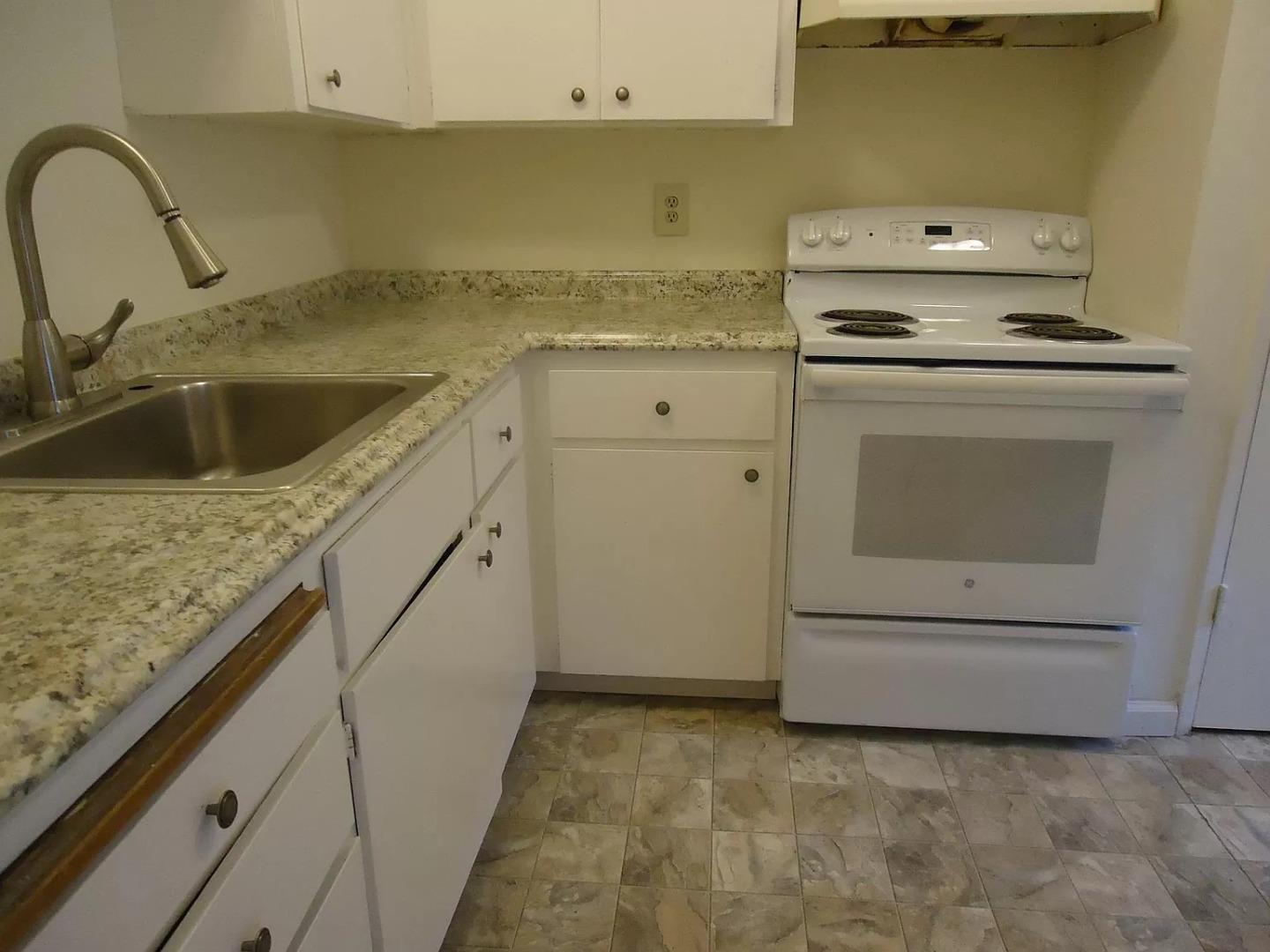 195 East Reed Street, Unit 4 San Jose, CA 95112 - Photo 5 of 11 a kitchen with granite countertop a sink a stove and cabinets