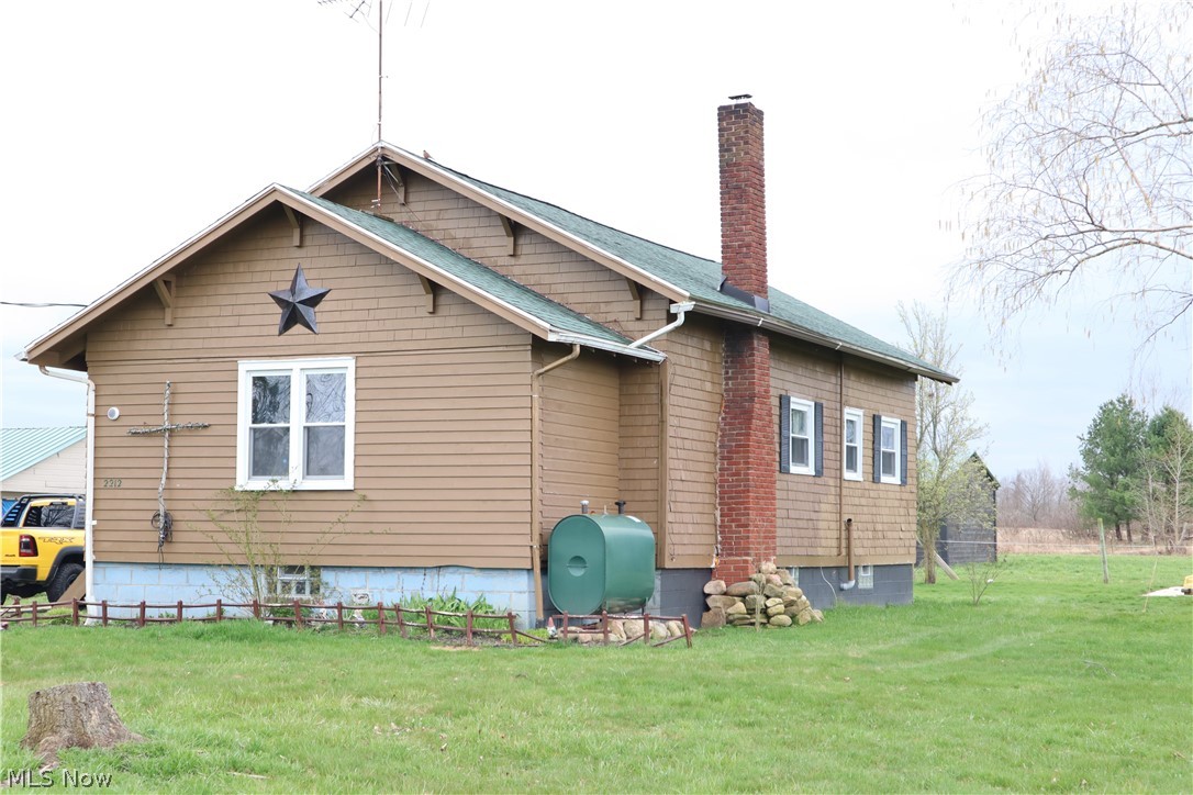 2212 Sentinel Road Dorset, OH 44032 - Photo 1 of 24 Back of house featuring a lawn