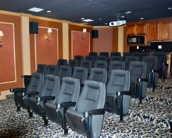 a hallway with painting on the wall and a potted plant