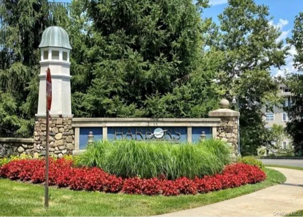 a front view of a house with a yard and potted plants