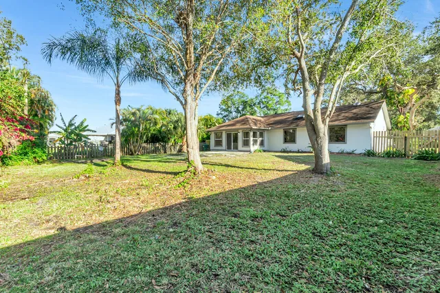 a view of a house with swimming pool and tree s