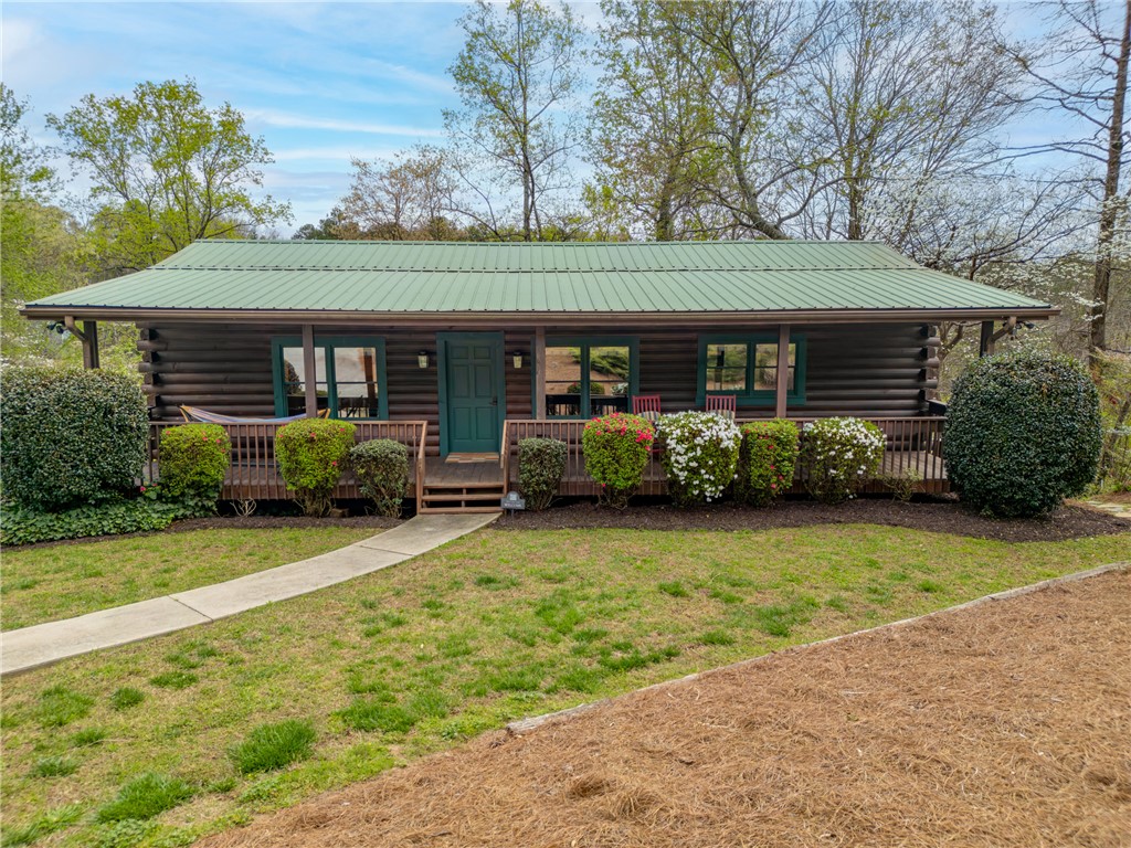 203 Little Lane Seneca, SC 29672 - Photo 4 of 48 This charming cabin home provides a peaceful escape, blending seamlessly with its lush natural surroundings.