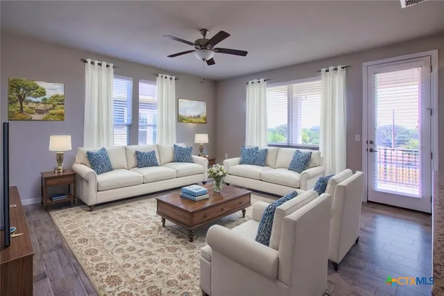 a living room with furniture and wooden floor