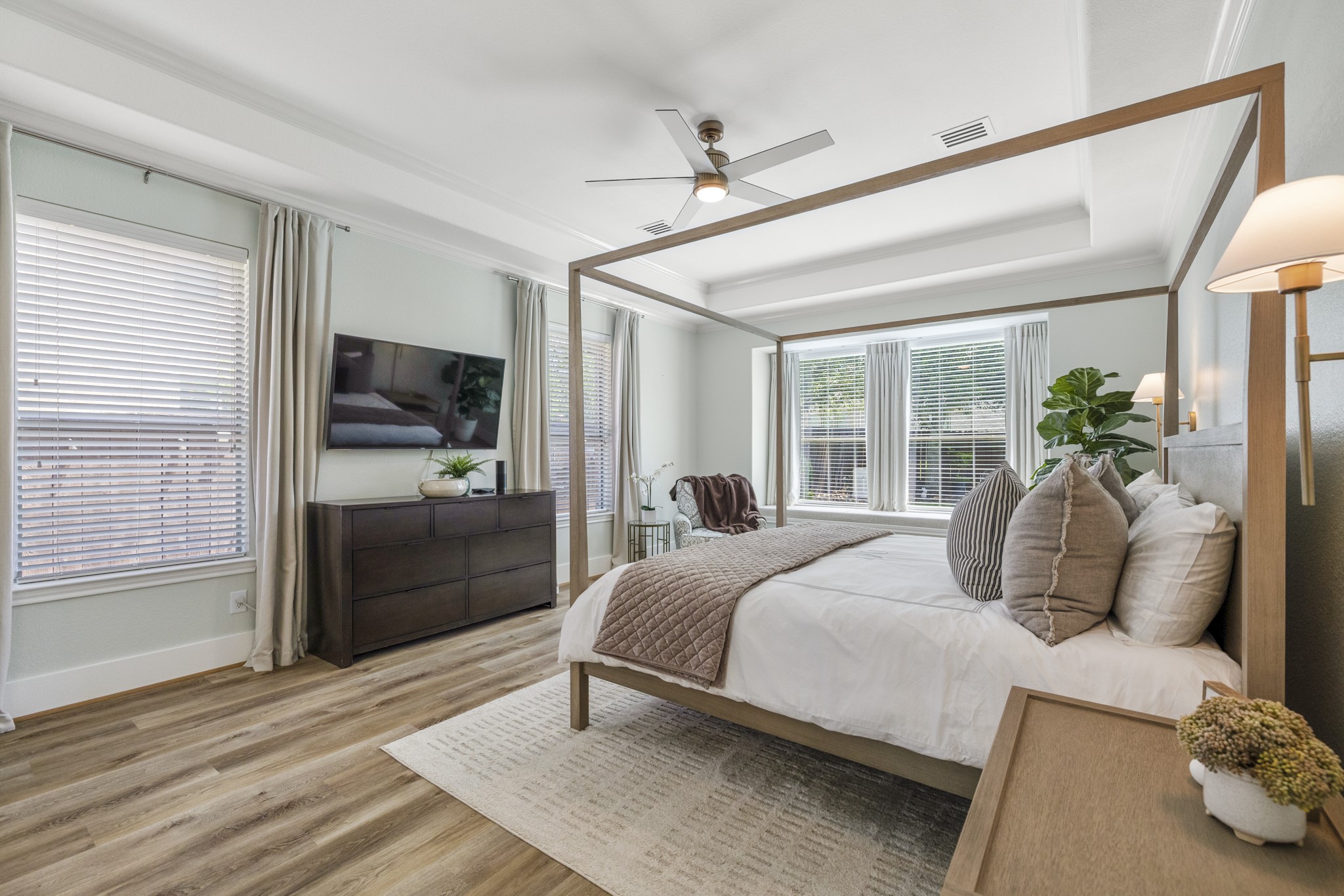 26 Winhall Place The Woodlands, TX 77354 - Photo 23 of 49 a bedroom with a bed flat screen tv and a large window