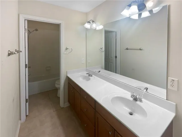 a bathroom with a sink double vanity and a mirror
